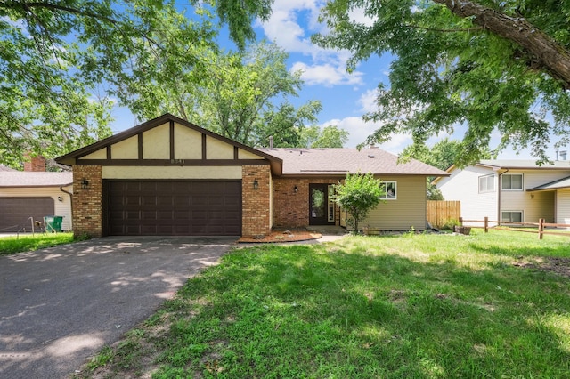 8341 Abbott Ave N, Brooklyn Park, MN 55443 - view of front of house with an attached garage, asphalt driveway, and brick siding
