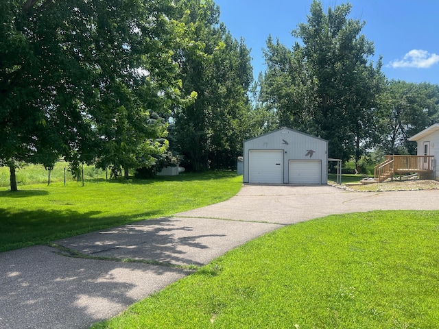 62871 230th St, Litchfield, MN 55355 - view of front of house featuring an outdoor structure, a detached garage, a front yard, and a wooden deck