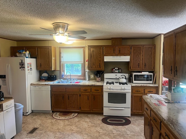 62871 230th St, Litchfield, MN 55355 - kitchen featuring white appliances, brown cabinets, under cabinet range hood, a textured ceiling, and a ceiling fan