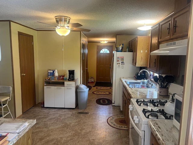 62871 230th St, Litchfield, MN 55355 - kitchen with under cabinet range hood, white appliances, a textured ceiling, a ceiling fan, and light countertops