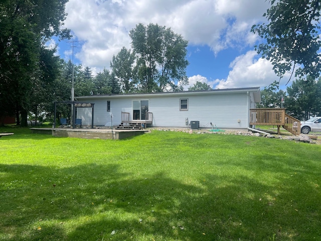 62871 230th St, Litchfield, MN 55355 - rear view of property featuring a lawn and a wooden deck