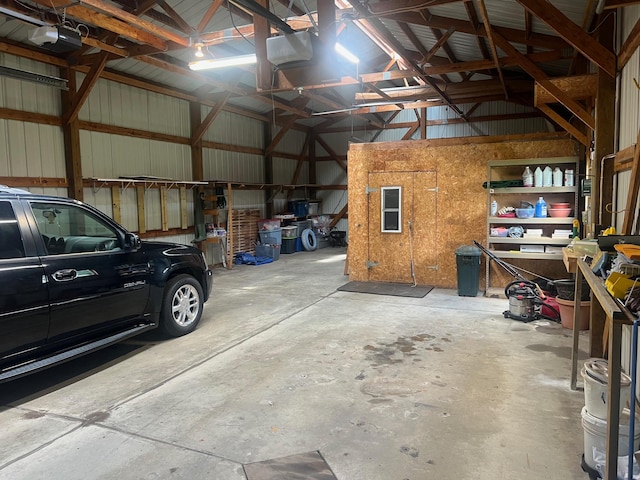 62871 230th St, Litchfield, MN 55355 - garage featuring a garage door opener and metal wall