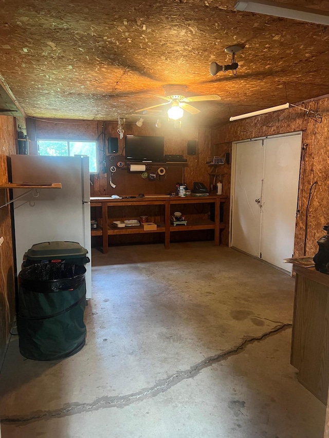 62871 230th St, Litchfield, MN 55355 - garage featuring a workshop area, freestanding refrigerator, and a ceiling fan