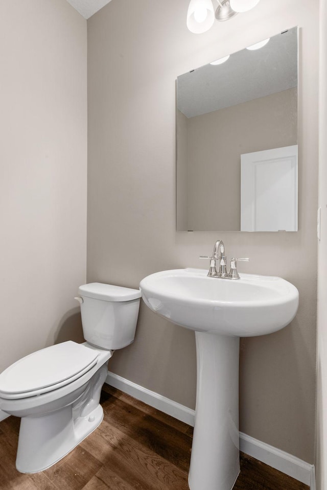 17233 61st St NE, Otsego, MN 55374 - half bathroom featuring toilet and wood finished floors