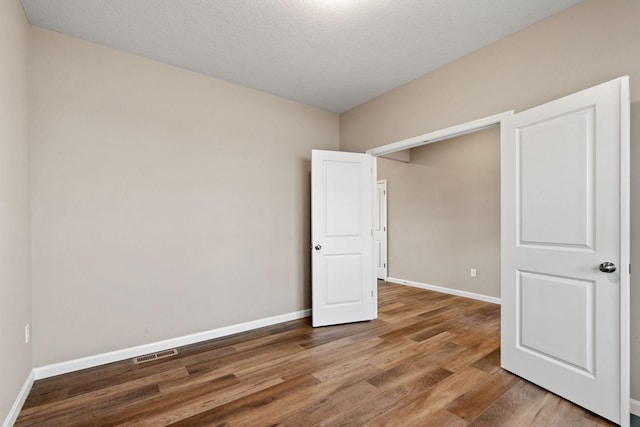17233 61st St NE, Otsego, MN 55374 - unfurnished bedroom with wood finished floors and baseboards