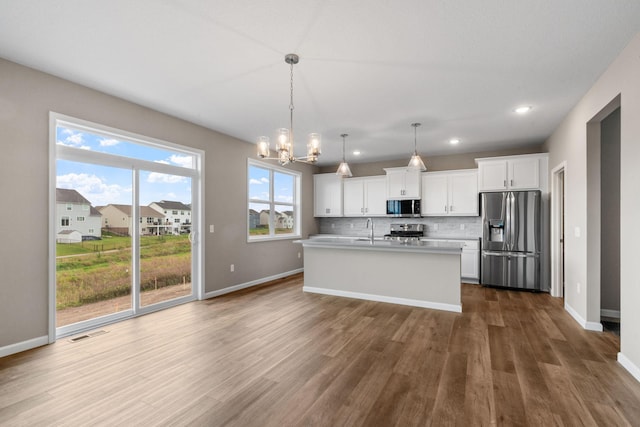17233 61st St NE, Otsego, MN 55374 - kitchen with appliances with stainless steel finishes, dark wood-type flooring, a chandelier, tasteful backsplash, and white cabinets
