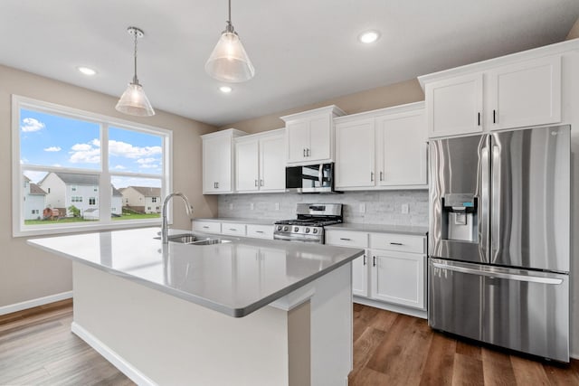 17233 61st St NE, Otsego, MN 55374 - kitchen featuring stainless steel appliances, an island with sink, tasteful backsplash, dark wood finished floors, and recessed lighting