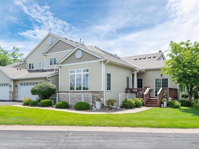 2606 Boulder Way, Burnsville, MN 55337 - craftsman-style home featuring roof with shingles, stone siding, a front yard, an attached garage, and a wooden deck