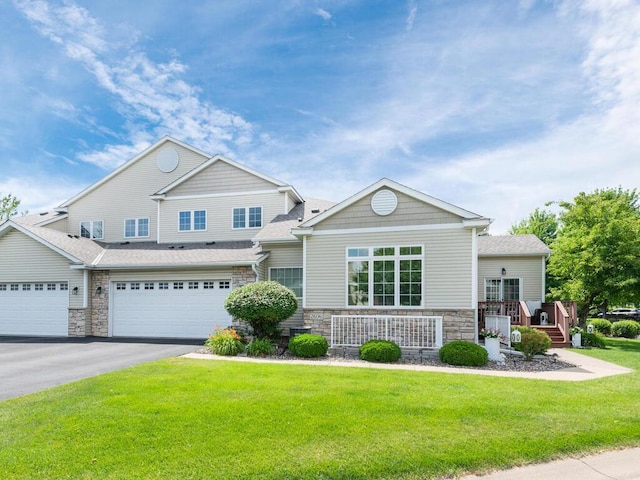 2606 Boulder Way, Burnsville, MN 55337 - craftsman house with stone siding, asphalt driveway, a front lawn, a shingled roof, and an attached garage