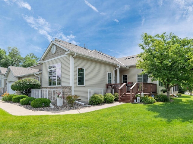 2606 Boulder Way, Burnsville, MN 55337 - view of side of property featuring a lawn, a shingled roof, a wooden deck, and stone siding