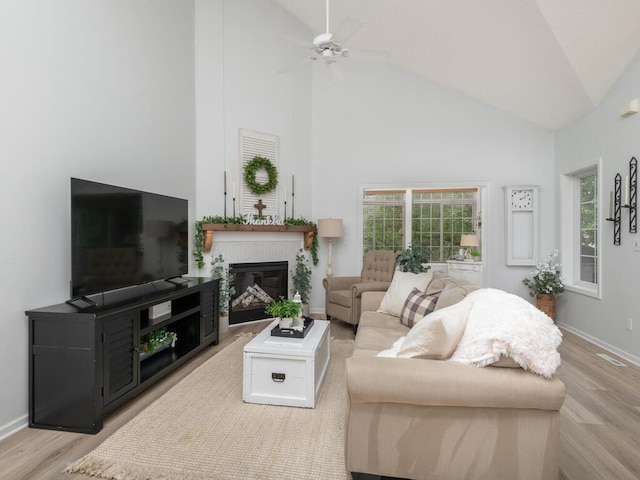 2606 Boulder Way, Burnsville, MN 55337 - living room with wood finished floors, a glass covered fireplace, high vaulted ceiling, and a ceiling fan
