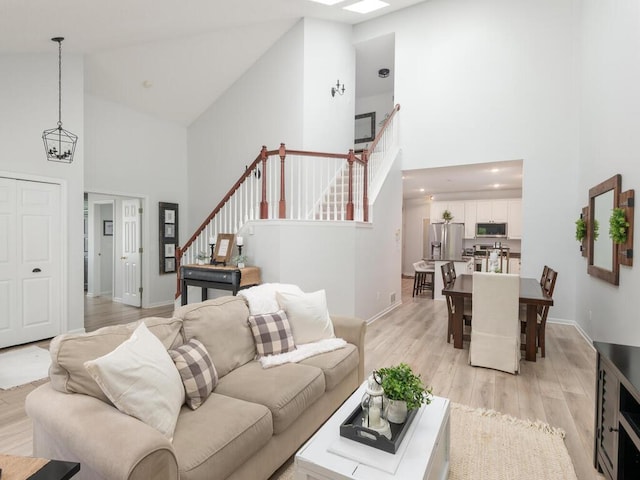 2606 Boulder Way, Burnsville, MN 55337 - living room with high vaulted ceiling, stairway, and light wood-style floors