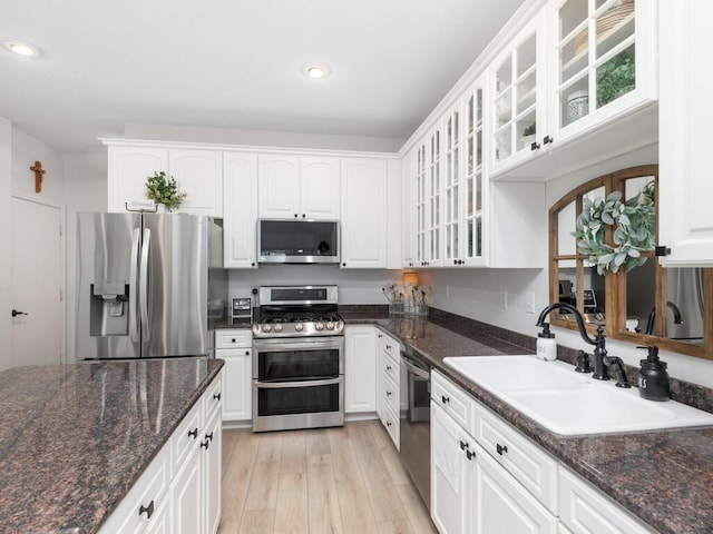 2606 Boulder Way, Burnsville, MN 55337 - kitchen with appliances with stainless steel finishes, recessed lighting, white cabinets, light wood finished floors, and glass insert cabinets