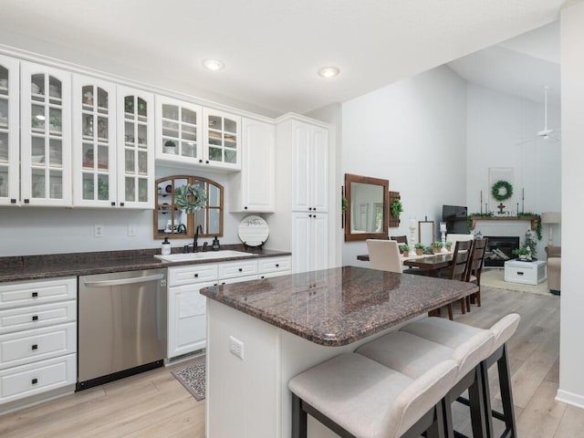 2606 Boulder Way, Burnsville, MN 55337 - kitchen featuring dishwasher, glass insert cabinets, a breakfast bar, white cabinets, and light wood-style floors
