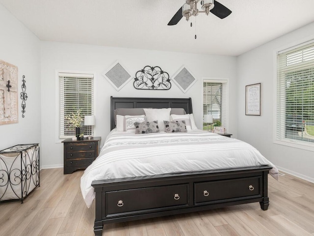 2606 Boulder Way, Burnsville, MN 55337 - bedroom featuring multiple windows, light wood finished floors, and ceiling fan