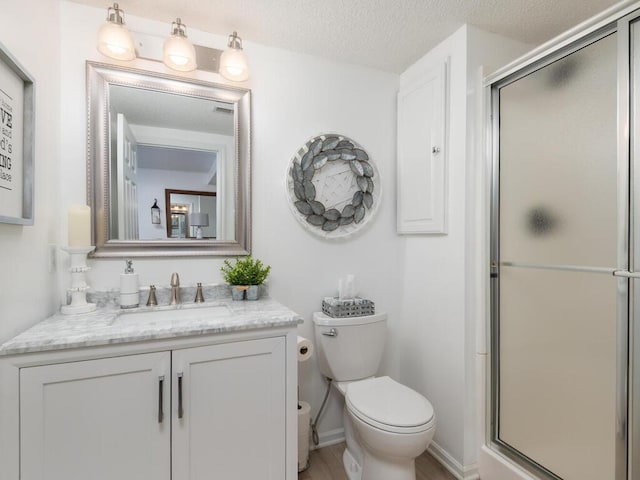 2606 Boulder Way, Burnsville, MN 55337 - bathroom with vanity, a stall shower, and a textured ceiling