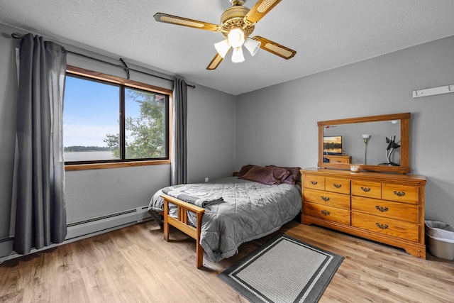 30675 Park St Unit 209, Lindstrom, MN 55045 - bedroom with light wood-style flooring, ceiling fan, and a textured ceiling