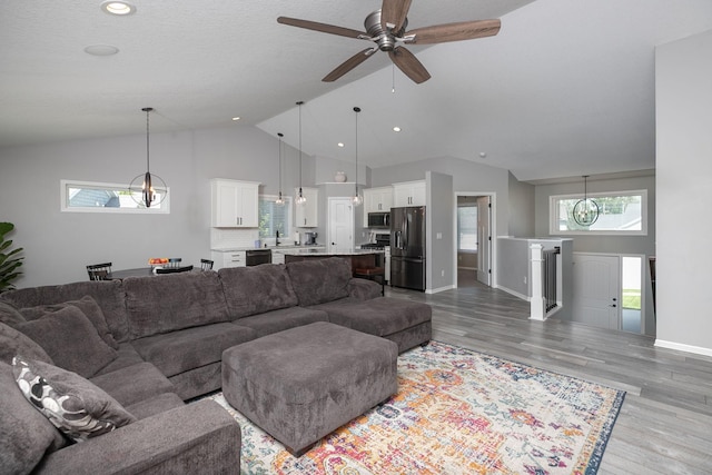 3875 Virgo Ln SW, Rochester, MN 55902 - living area featuring vaulted ceiling, light wood-style flooring, ceiling fan, and recessed lighting