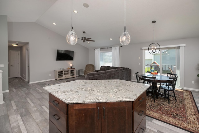 3875 Virgo Ln SW, Rochester, MN 55902 - kitchen with lofted ceiling, ceiling fan, light wood-style flooring, pendant lighting, and dark brown cabinetry