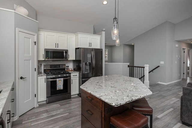 3875 Virgo Ln SW, Rochester, MN 55902 - kitchen featuring stainless steel appliances, light wood-type flooring, white cabinets, tasteful backsplash, and recessed lighting