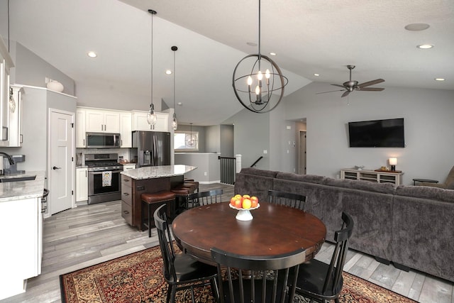 3875 Virgo Ln SW, Rochester, MN 55902 - dining room with lofted ceiling, light wood-style floors, a ceiling fan, a chandelier, and recessed lighting