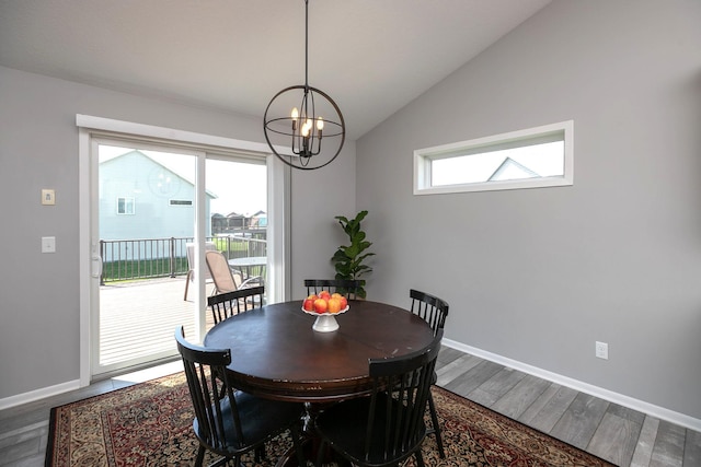 3875 Virgo Ln SW, Rochester, MN 55902 - dining space with a chandelier, vaulted ceiling, and wood finished floors