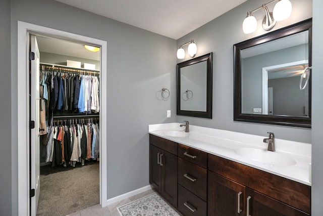 3875 Virgo Ln SW, Rochester, MN 55902 - full bath with double vanity, a walk in closet, and tile patterned floors