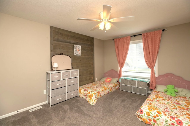 3875 Virgo Ln SW, Rochester, MN 55902 - bedroom with dark carpet, wooden walls, a ceiling fan, and a textured ceiling