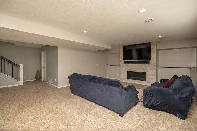 3875 Virgo Ln SW, Rochester, MN 55902 - carpeted living room featuring a fireplace, recessed lighting, and stairs