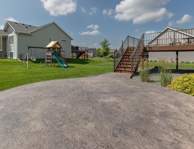3875 Virgo Ln SW, Rochester, MN 55902 - view of green lawn featuring stairway, a playground, and a wooden deck