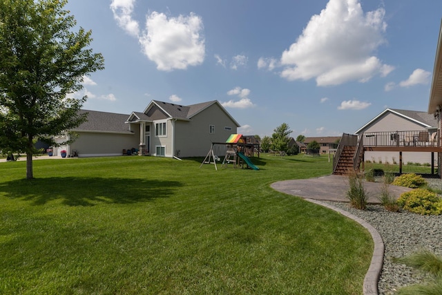 3875 Virgo Ln SW, Rochester, MN 55902 - view of grassy yard featuring a patio area, a deck, a playground, and stairs