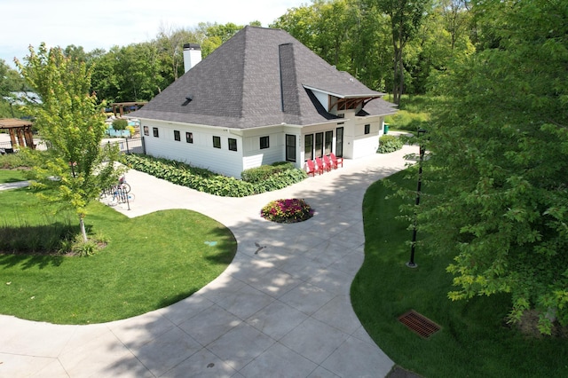 4559 Meadowview Ln, Minnetrista, MN 55331 - view of front of property with a shingled roof, a chimney, driveway, a front yard, and a garage