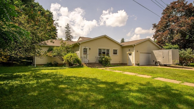507 15th St SE, Menomonie, WI 54751 - view of front facade featuring an attached garage, a front yard, and driveway