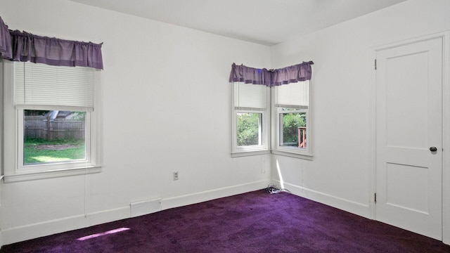 507 15th St SE, Menomonie, WI 54751 - unfurnished room with dark colored carpet and baseboards