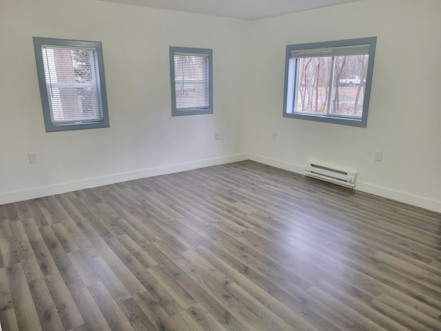 1410 5th St, Saint Paul Park, MN 55071 - empty room featuring a baseboard radiator and dark wood-type flooring