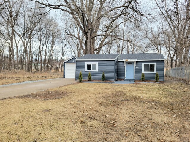 1410 5th St, Saint Paul Park, MN 55071 - view of front of property with concrete driveway, a detached garage, and roof with shingles