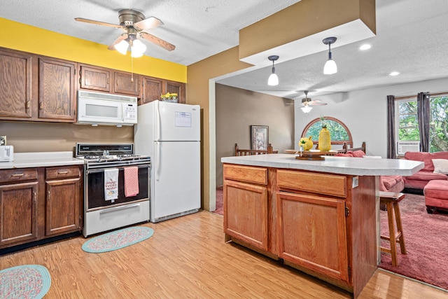 5781 Needham Ave NE, Saint Michael, MN 55376 - kitchen featuring white appliances, ceiling fan, a textured ceiling, light countertops, and light wood finished floors