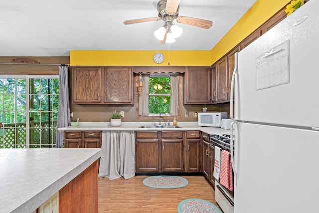 5781 Needham Ave NE, Saint Michael, MN 55376 - kitchen featuring white appliances, light countertops, healthy amount of natural light, and a textured ceiling