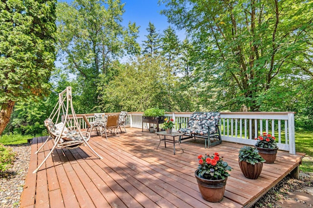 5781 Needham Ave NE, Saint Michael, MN 55376 - wooden deck featuring outdoor dining area and view of wooded area