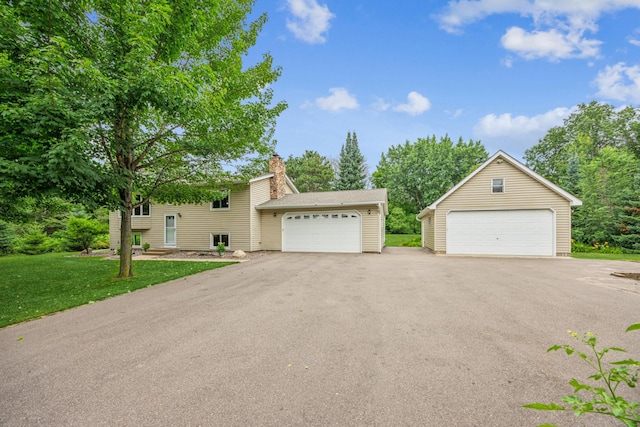 487 Lois Ln, Lino Lakes, MN 55014 - view of front of property featuring a chimney, a garage, and a front lawn