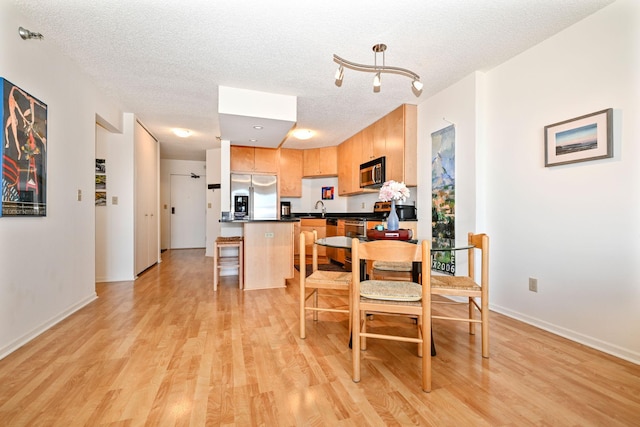 401 1st St Unit 1312, Minneapolis, MN 55401 - dining space featuring light wood finished floors and a textured ceiling