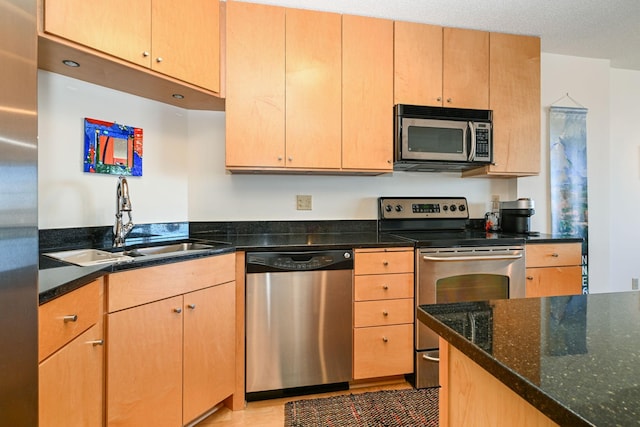 401 1st St Unit 1312, Minneapolis, MN 55401 - kitchen featuring appliances with stainless steel finishes, dark stone countertops, and light brown cabinetry