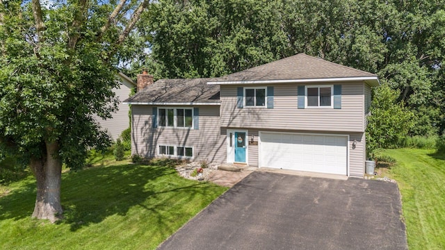 6240 Decatur Ave N, Brooklyn Park, MN 55428 - split level home with a garage, driveway, a front yard, a chimney, and roof with shingles