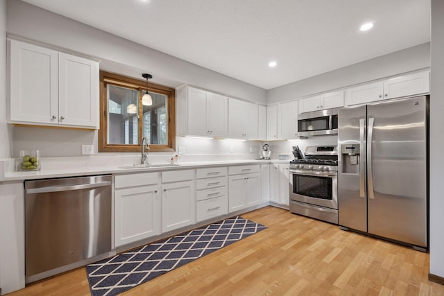 6240 Decatur Ave N, Brooklyn Park, MN 55428 - kitchen featuring stainless steel appliances, white cabinetry, light wood finished floors, light countertops, and recessed lighting