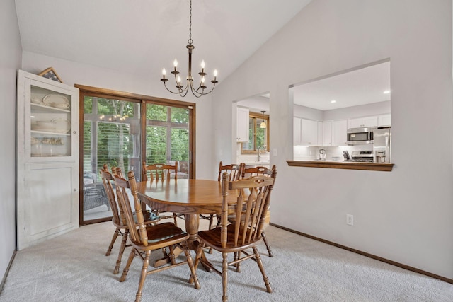 6240 Decatur Ave N, Brooklyn Park, MN 55428 - dining space featuring a chandelier, lofted ceiling, and light colored carpet
