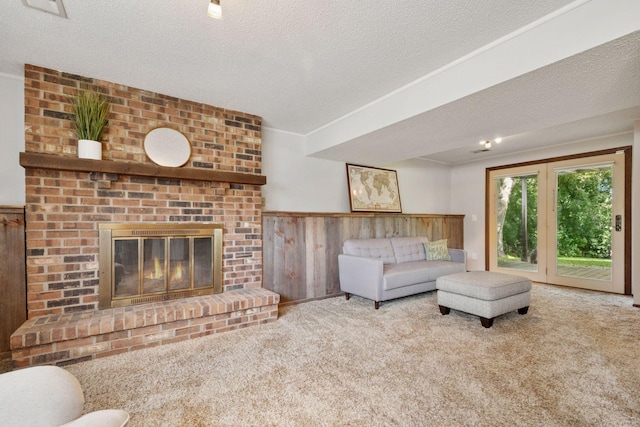 6240 Decatur Ave N, Brooklyn Park, MN 55428 - living area with carpet, a fireplace, a textured ceiling, and wood walls