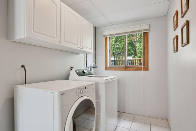 6240 Decatur Ave N, Brooklyn Park, MN 55428 - washroom with cabinet space, washer and dryer, and light tile patterned floors