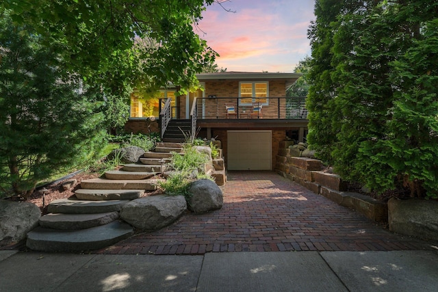 1228 Palace Ave, Saint Paul, MN 55105 - view of front of property featuring stairway, decorative driveway, a garage, and a porch
