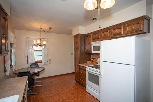 1705 California Ave E, Saint Paul, MN 55106 - kitchen featuring white appliances, a chandelier, light countertops, brown cabinets, and pendant lighting