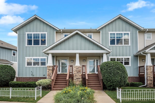 1358 Phalen Blvd, Saint Paul, MN 55106 - view of front of property with board and batten siding, stairway, and covered porch